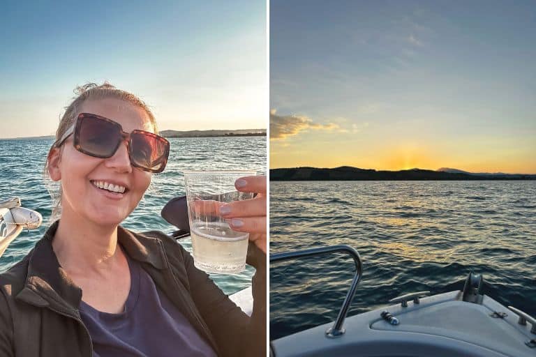 Kasia wearing sunglasses and holding a glass of white wine on a boat